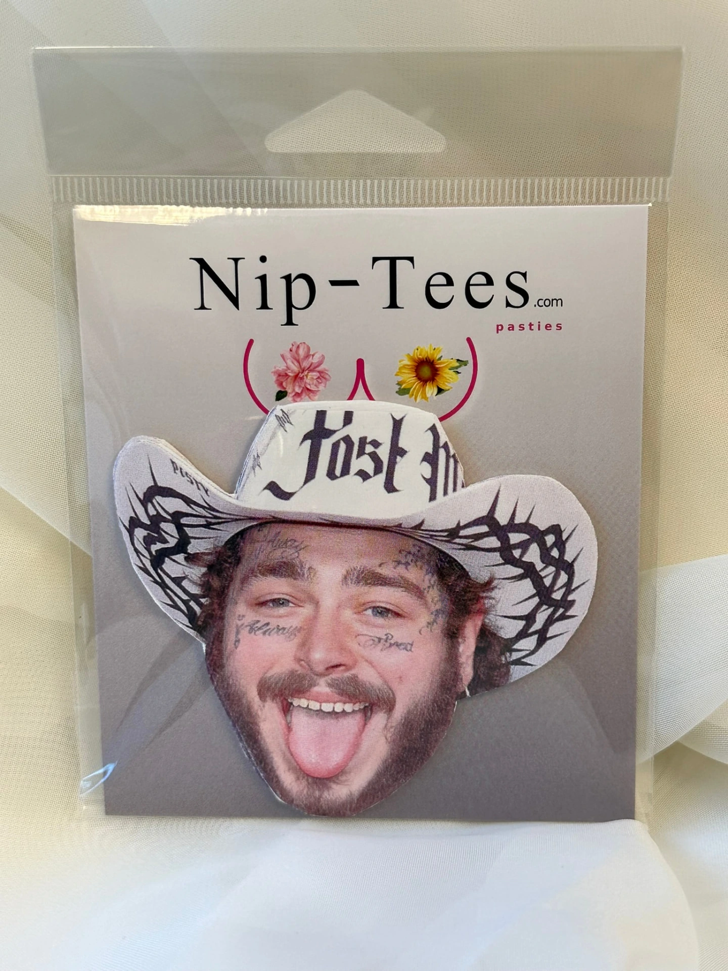 Custom face pastie wearing a cowboy hat, in Niptees packaging